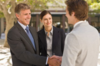 Business people who know each other meet in the street